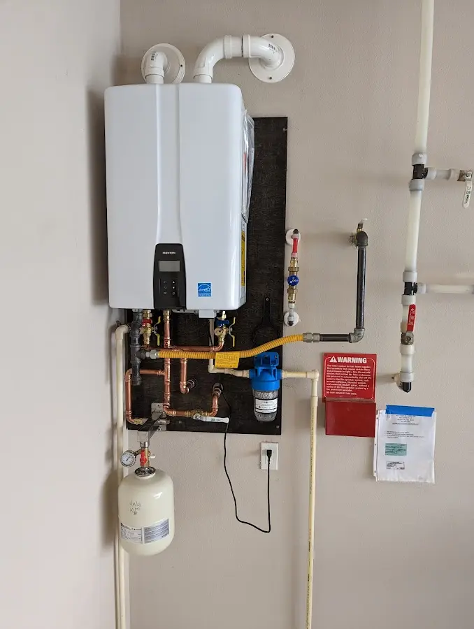 Professional plumber installing copper piping in a Warm Mineral Springs home